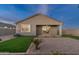 Back of home features an outdoor patio and living space plus green artificial turf at 35961 W San Ildefanso Ave, Maricopa, AZ 85138