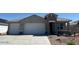 Charming single-story home featuring a spacious three-car garage and stone accents at 35961 W San Ildefanso Ave, Maricopa, AZ 85138