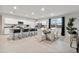Open-concept kitchen with a large island, stainless steel appliances, and a dining area with ample seating at 35961 W San Ildefanso Ave, Maricopa, AZ 85138