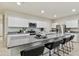 Spacious kitchen with granite countertops, stainless steel appliances, and a large center island with seating at 35961 W San Ildefanso Ave, Maricopa, AZ 85138