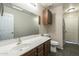 Well-lit bathroom featuring a spacious vanity, a toilet, and a shower/bath combo at 36307 W El Greco St, Maricopa, AZ 85138