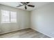 Bedroom with light-colored wood flooring and a large window at 36307 W El Greco St, Maricopa, AZ 85138
