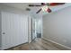 Bedroom featuring wood-look floors, a ceiling fan, and a closet with sliding doors at 36307 W El Greco St, Maricopa, AZ 85138