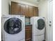 Bright laundry room with modern washer and dryer and plenty of storage at 36307 W El Greco St, Maricopa, AZ 85138