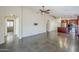 Spacious living room with modern tile flooring, neutral walls, and open access to the kitchen at 36307 W El Greco St, Maricopa, AZ 85138