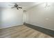 Open living area with wood floors, ceiling fan, and ample natural light at 36307 W El Greco St, Maricopa, AZ 85138