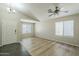 Bright living room with neutral walls, large windows and a ceiling fan at 36307 W El Greco St, Maricopa, AZ 85138