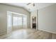 Spacious bedroom with vaulted ceilings, wood flooring, and an arched doorway leading to the ensuite bathroom at 36307 W El Greco St, Maricopa, AZ 85138