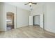The main bedroom has vaulted ceilings, light wood floors, and an adjoining bathroom at 36307 W El Greco St, Maricopa, AZ 85138