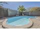 Backyard pool featuring a stone border and a palm tree in the background at 36307 W El Greco St, Maricopa, AZ 85138