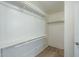 Walk-in closet with shelves, closet rods, and light-colored wood flooring at 36307 W El Greco St, Maricopa, AZ 85138