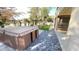 Hot tub on paved backyard patio with a grass lawn behind it at 3807 E Latham Ct, Gilbert, AZ 85297