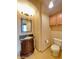 Powder bathroom with dark wood vanity, granite countertop, and tiled floor at 3807 E Latham Ct, Gilbert, AZ 85297