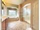 Bright bathroom features double sinks, tub, and glass shower at 3807 E Latham Ct, Gilbert, AZ 85297