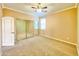 Comfortable bedroom features neutral carpeting, a ceiling fan, and mirrored closet at 3807 E Latham Ct, Gilbert, AZ 85297
