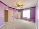Large bedroom in purple with big window, archways, and neutral carpet at 3807 E Latham Ct, Gilbert, AZ 85297