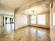 Open-concept dining room with tray ceilings, chandelier, and three large windows for natural light at 3807 E Latham Ct, Gilbert, AZ 85297