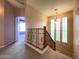 Upstairs hallway with decorative banister, carpeted floor and natural light at 3807 E Latham Ct, Gilbert, AZ 85297