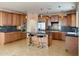 Spacious kitchen with custom cabinets, granite countertops, stainless steel appliances, and a center island at 3807 E Latham Ct, Gilbert, AZ 85297
