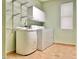 Practical laundry room with cabinets, utility sink, washer, and dryer at 3807 E Latham Ct, Gilbert, AZ 85297