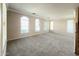 Bright living room with neutral walls, carpeted floors, and lots of windows letting in plenty of natural light at 3807 E Latham Ct, Gilbert, AZ 85297