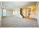 Bright living room with neutral walls, plush carpet, and staircase to second level at 3807 E Latham Ct, Gilbert, AZ 85297