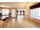 Open living space with kitchen island, tile flooring, and door to the outside at 3807 E Latham Ct, Gilbert, AZ 85297
