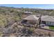 Aerial shot of a backyard with a covered patio, BBQ, and desert landscaping for relaxed outdoor living at 41310 N Clear Crossing Ct, Anthem, AZ 85086