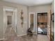 Hallway featuring tile floors, artwork, and a view of the front security door at 41310 N Clear Crossing Ct, Anthem, AZ 85086