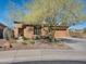 Charming front exterior with desert landscaping, mature trees, and a two-car garage at 41310 N Clear Crossing Ct, Anthem, AZ 85086