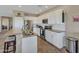 Updated kitchen showcasing granite countertops, stainless steel appliances, and white cabinetry at 41310 N Clear Crossing Ct, Anthem, AZ 85086