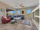 Spacious living room featuring a comfortable sectional sofa, accent rug, and beautiful outdoor views at 41310 N Clear Crossing Ct, Anthem, AZ 85086