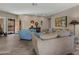 Spacious living area featuring tile floors, comfortable seating, and abundant natural light at 41310 N Clear Crossing Ct, Anthem, AZ 85086