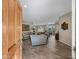 Open-concept living room with wood-look tile floors and comfortable seating arrangement at 41310 N Clear Crossing Ct, Anthem, AZ 85086