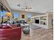 Bright and airy living room with a large sectional, stylish rug, and built-in shelving unit at 41310 N Clear Crossing Ct, Anthem, AZ 85086