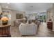 Inviting living room features comfortable seating, tile floors, and seamless transition to dining area at 41310 N Clear Crossing Ct, Anthem, AZ 85086