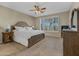Serene main bedroom with a rustic wooden bed frame, side tables, and window shutters at 41310 N Clear Crossing Ct, Anthem, AZ 85086