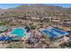 Aerial view of the community pool, clubhouse, and tennis courts, offering a variety of leisure activities at 41310 N Clear Crossing Ct, Anthem, AZ 85086