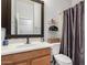 Well-maintained bathroom featuring a vanity with storage, open shelves, and a shower with a curtain at 42207 N 45Th Dr, Phoenix, AZ 85086