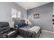Comfortable bedroom with a wooden-frame bed, a cozy chair, and natural light from the window at 42207 N 45Th Dr, Phoenix, AZ 85086