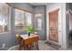 Cozy breakfast nook with a charming wooden table, three chairs, natural light, and outdoor access at 42207 N 45Th Dr, Phoenix, AZ 85086