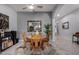 Charming dining area features a round wood table, four chairs, and an elegant mirror, perfect for Gathering meals at 42207 N 45Th Dr, Phoenix, AZ 85086