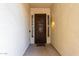 Elegant front entryway featuring a decorative iron door and stylish sconce lighting at 42207 N 45Th Dr, Phoenix, AZ 85086