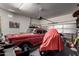 Spacious garage featuring a classic red car and ample storage space at 42207 N 45Th Dr, Phoenix, AZ 85086