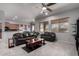 Inviting living room with leather seating, ceiling fan, and natural light, perfect for relaxing and entertaining at 42207 N 45Th Dr, Phoenix, AZ 85086