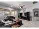 Cozy living room featuring a comfortable leather sofa and modern entertainment center at 42207 N 45Th Dr, Phoenix, AZ 85086