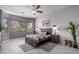Serene main bedroom featuring a ceiling fan, and large windows, creating a tranquil retreat for relaxation at 42207 N 45Th Dr, Phoenix, AZ 85086