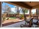 Cozy covered patio with outdoor seating and a view of the private backyard with a putting green at 42207 N 45Th Dr, Phoenix, AZ 85086
