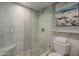 Modern bathroom with glass enclosed shower featuring custom tile design and a mosaic floor at 4303 E Cactus Rd # 308B, Phoenix, AZ 85032