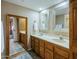 Elegant bathroom featuring double sinks with vanity and well lit mirror, complete with plenty of storage at 4303 E Cactus Rd # 308B, Phoenix, AZ 85032